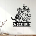 Tabby cat wall decor displayed on a light wood-paneled wall in a cozy home setting