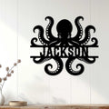 Octopus metal sign displayed on a light wood-paneled wall in a coastal home setting