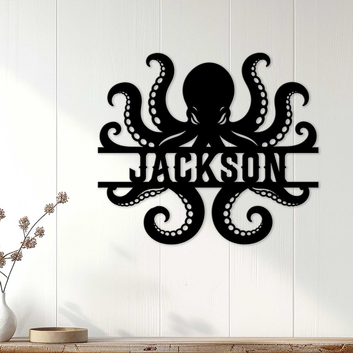 Octopus metal sign displayed on a light wood-paneled wall in a coastal home setting