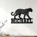 Black leopard wall sign displayed on a light paneled wall above a modern console