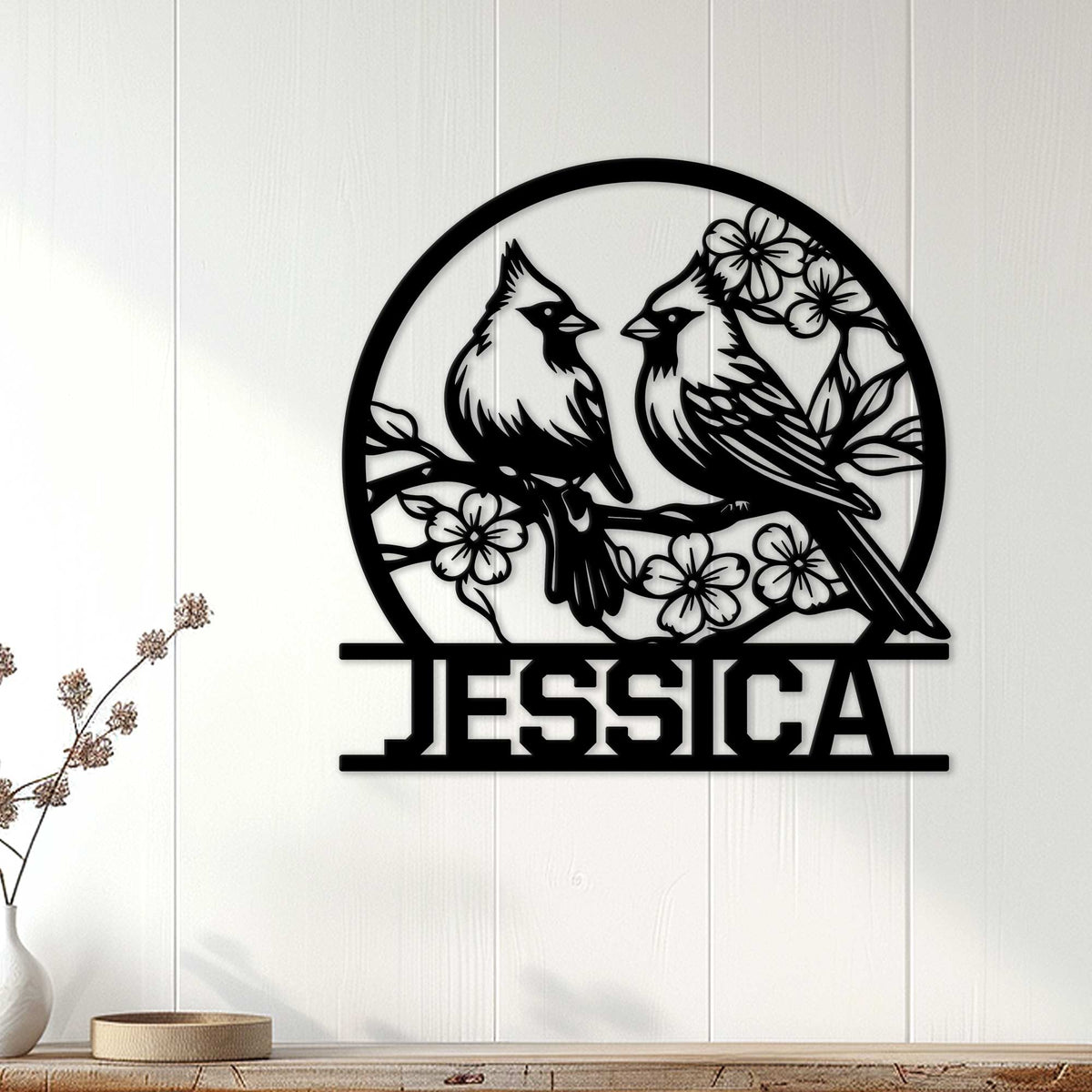 Cardinal wall decor displayed on a light wood wall above a console table in a bright home