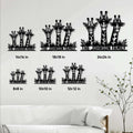 Giraffe family metal sign size guide showing multiple square size options in a living room setting
