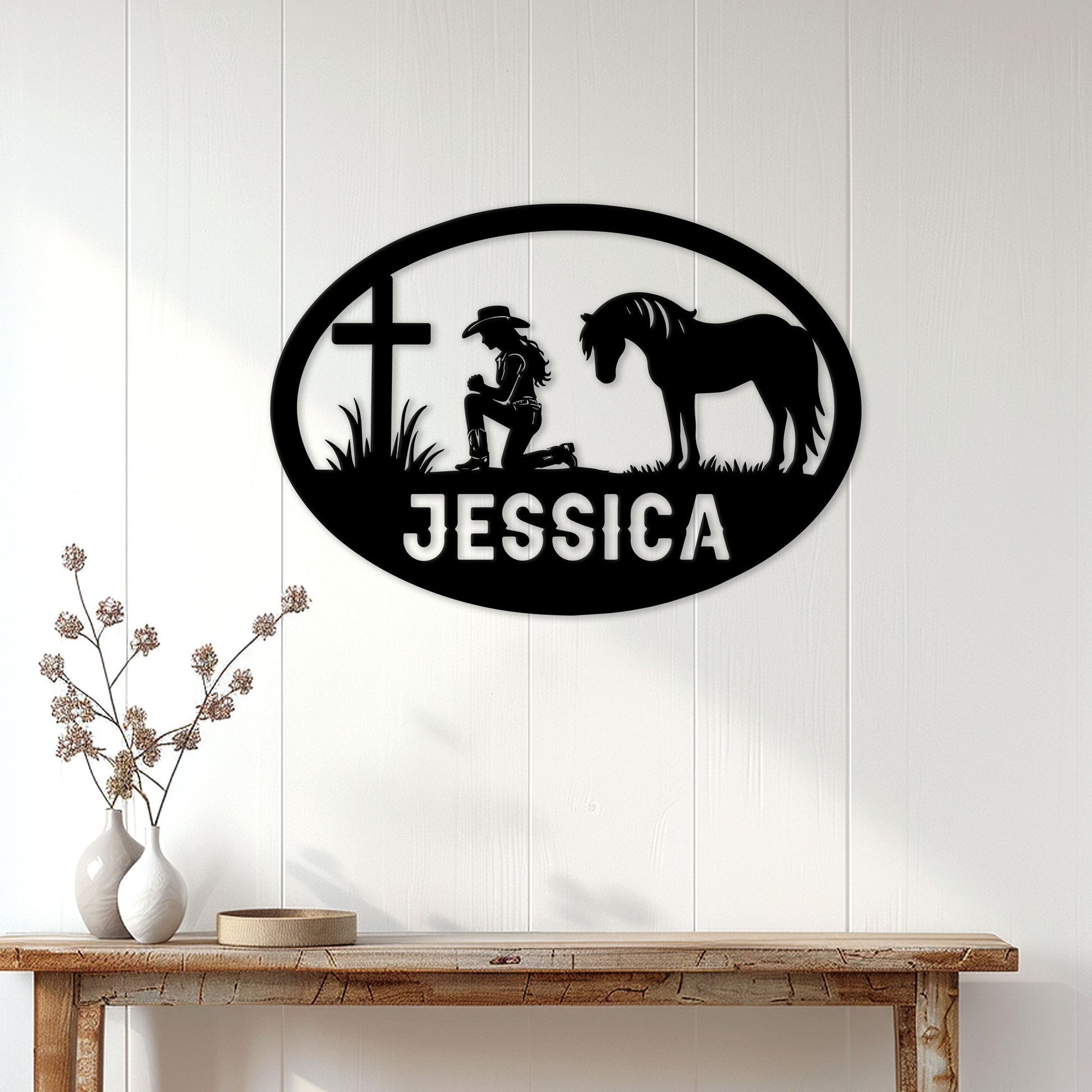 Cowgirl horse metal wall sign displayed on a light wood-paneled wall above a rustic console table