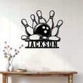 Bowling metal sign displayed on a bright paneled wall above a rustic console table