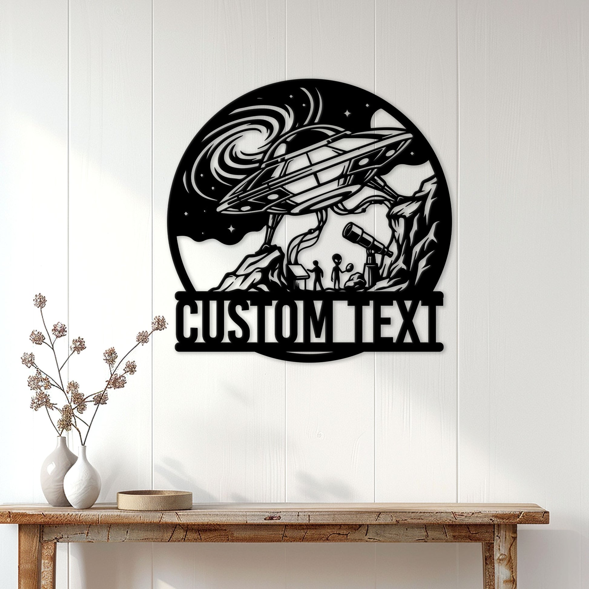 UFO metal wall sign displayed on a light paneled wall above a rustic console table