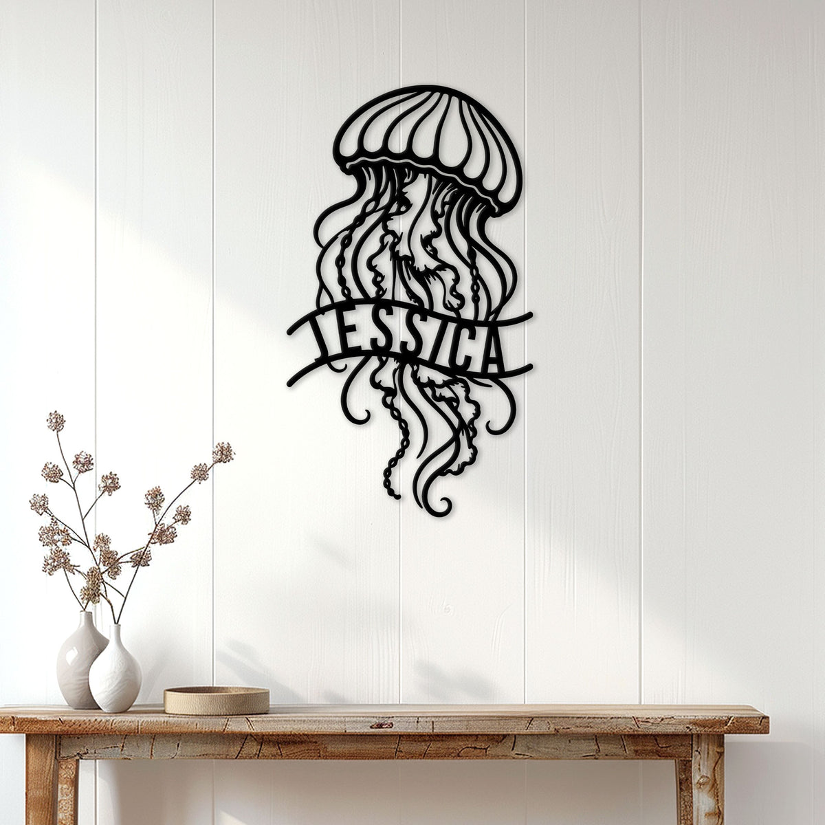 Jellyfish metal wall decor displayed on a white paneled wall above a rustic console table