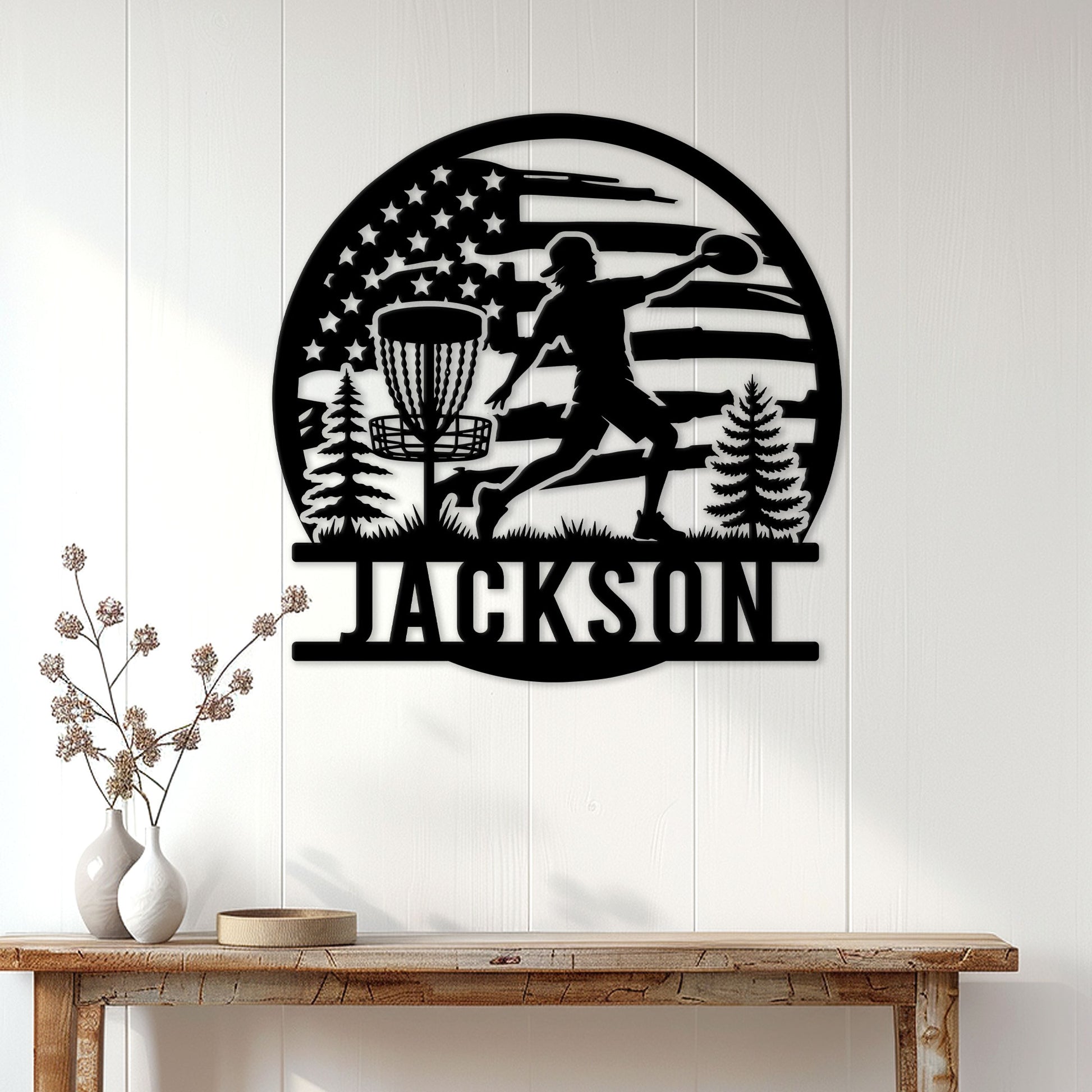 Disc golf wall decor displayed above a console table, featuring a silhouetted player and basket scene