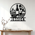 Black wine vineyard metal sign displayed on a white paneled wall above a rustic console table