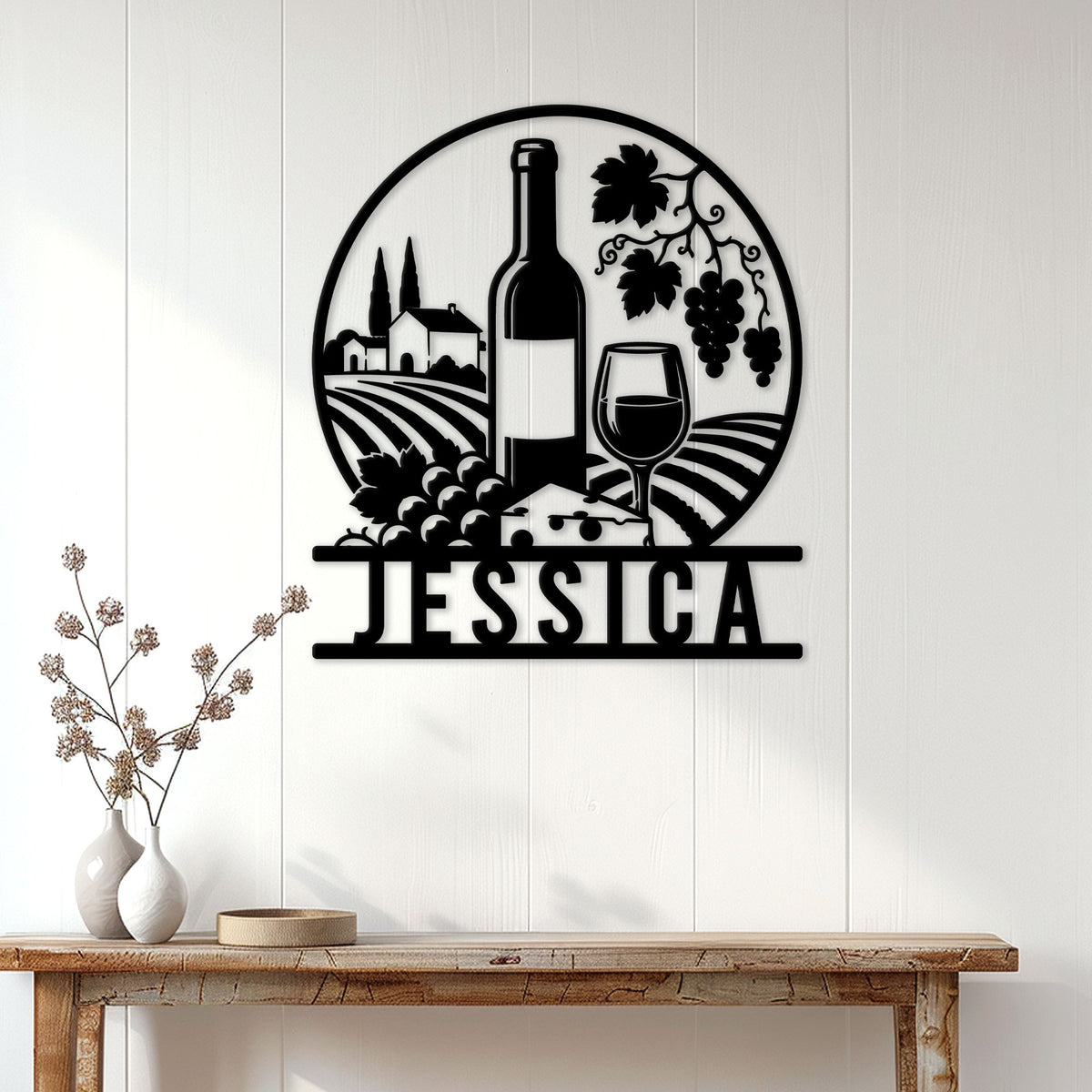 Black wine vineyard metal sign displayed on a white paneled wall above a rustic console table