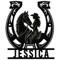 Black cowgirl and horse silhouette framed by a horseshoe on a custom metal sign