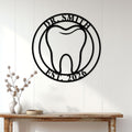 Dentist wall sign displayed on a white paneled wall above a wood console table