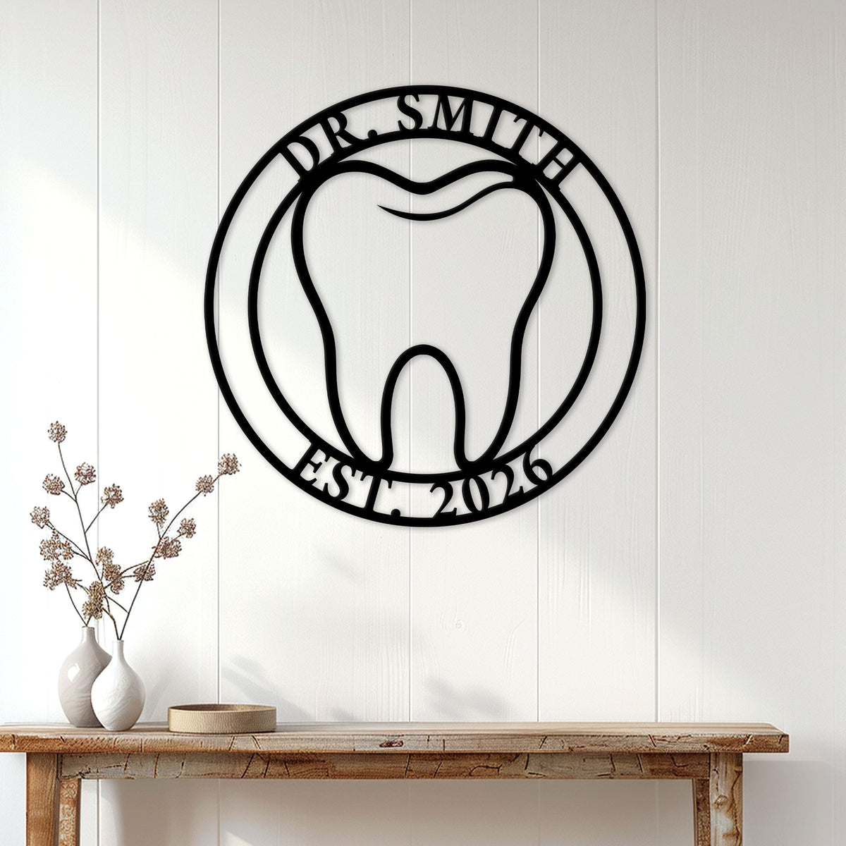 Dentist wall sign displayed on a white paneled wall above a wood console table