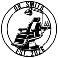 Dentist metal sign featuring a detailed dental chair, examination lamp, and instrument tray in a circular design