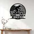 Cyclist wall decor displayed above a console table, featuring a rider silhouette and American flag