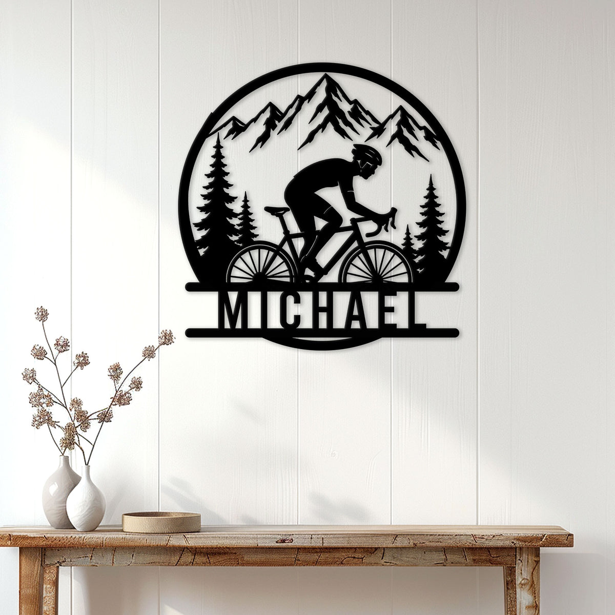 Cyclist wall sign displayed on a white paneled wall above a rustic console table
