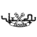 Custom plumber metal sign featuring crossed plumbing tools, pipework, and a bold curved banner design