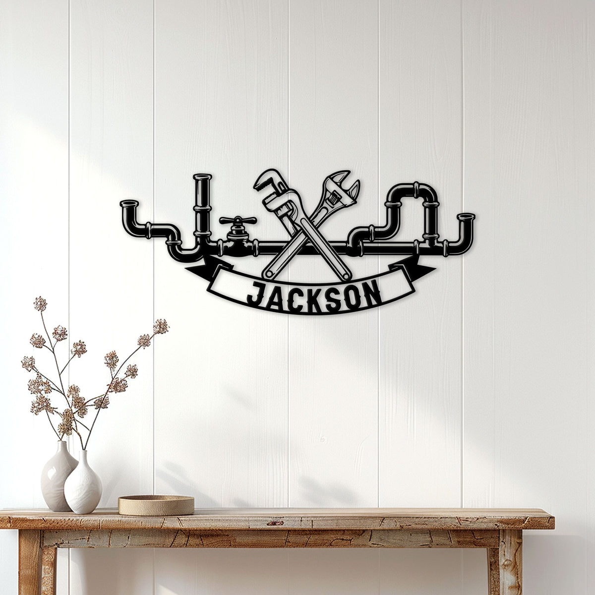 Plumber metal wall decor displayed on a light wood-paneled wall above a console table