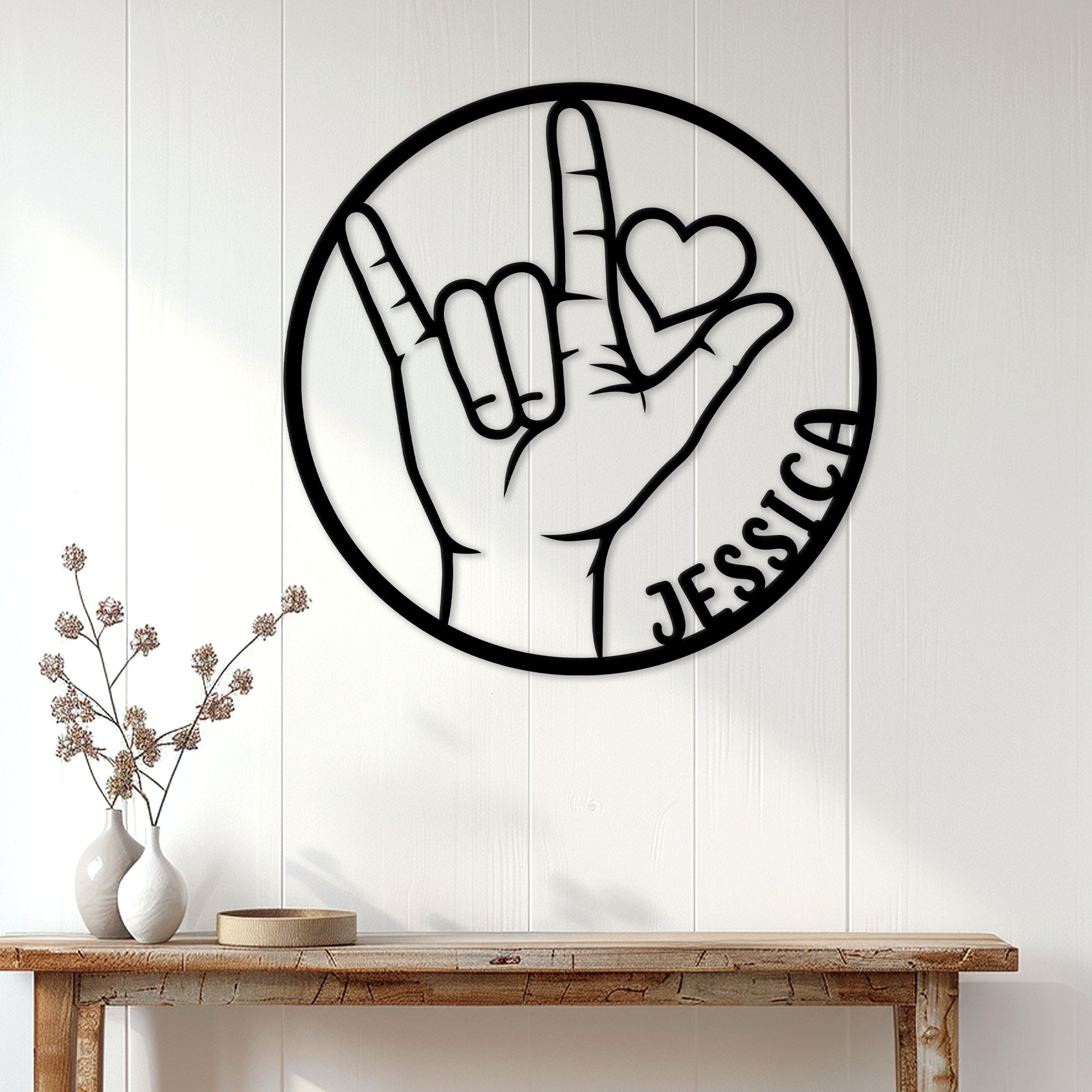 ASL sign language wall decor displayed on a bright paneled wall above a console table