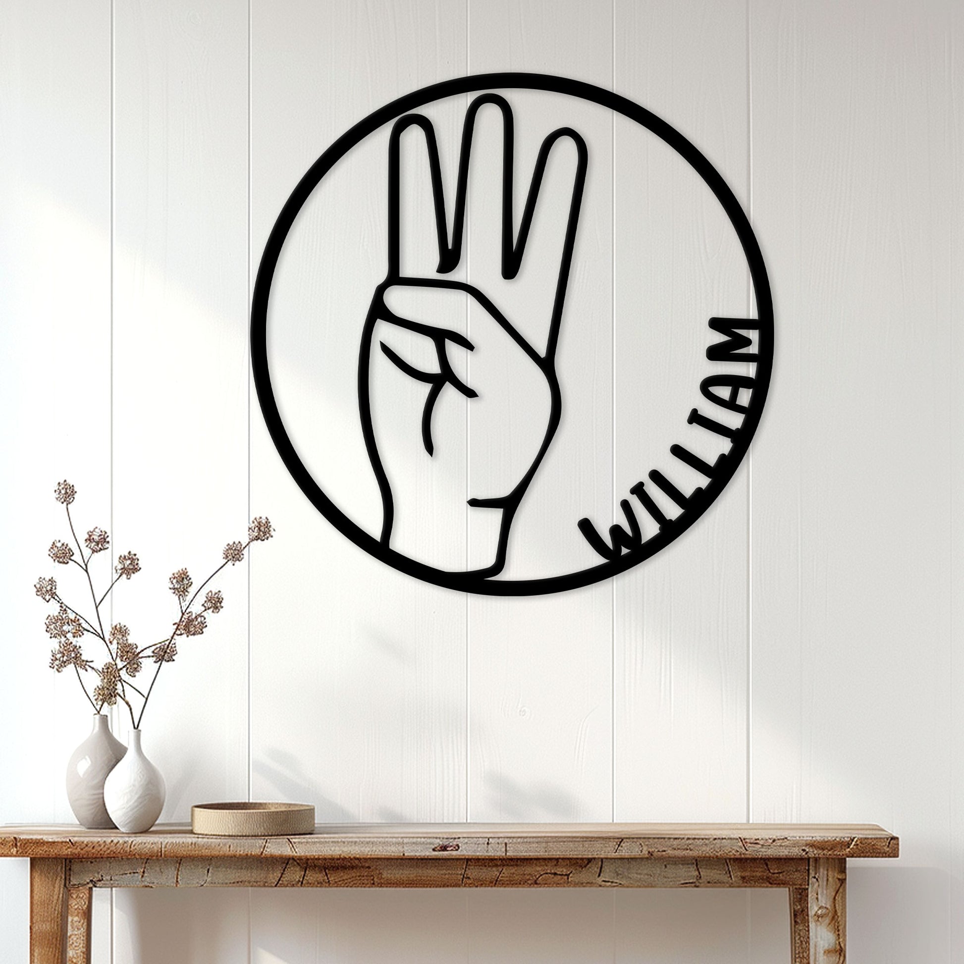 American Sign Language hand gesture metal sign styled as wall decor above a wood console table