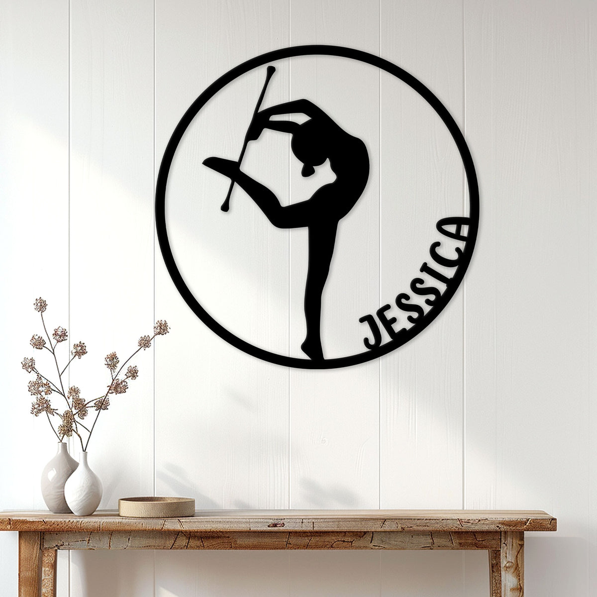 Baton twirling wall sign displayed on white paneling above a wooden console table