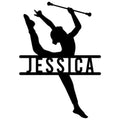 Black silhouette of a baton twirler performing a split with a raised baton on a metal sign