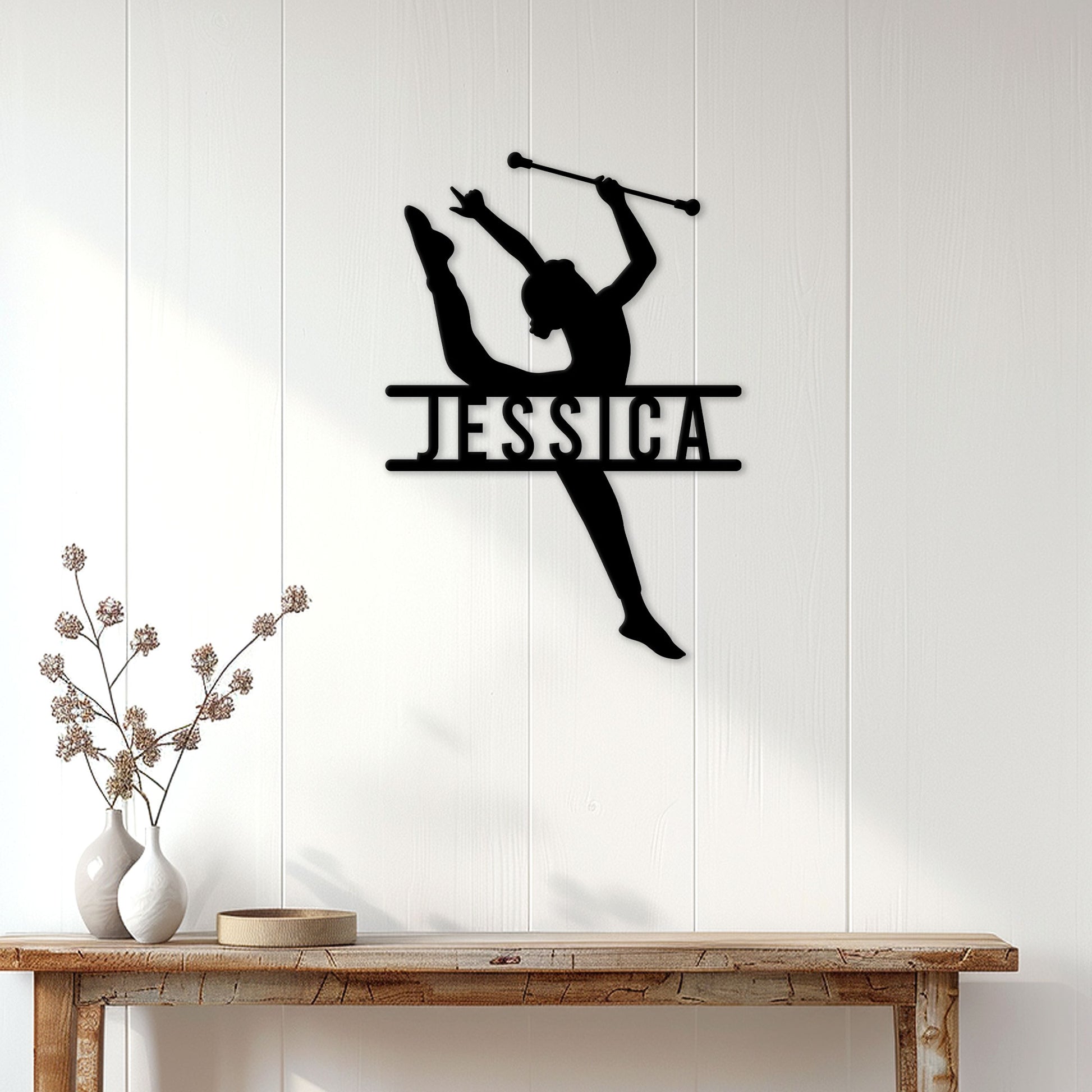 Baton twirling metal wall sign displayed above a console table in a bright home interior