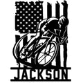 Patriotic cyclist metal sign featuring a road bike, rider silhouette, and American flag design