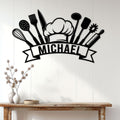 Chef kitchen wall sign displayed on a white wood-paneled wall above a console table