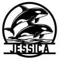 Circular orca metal sign featuring two killer whales leaping above stylized ocean waves