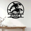 Orca metal wall sign displayed on white wood paneling above a console table in a bright home