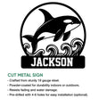Orca metal sign featuring a breaching whale, curling waves, and a bold rectangular base
