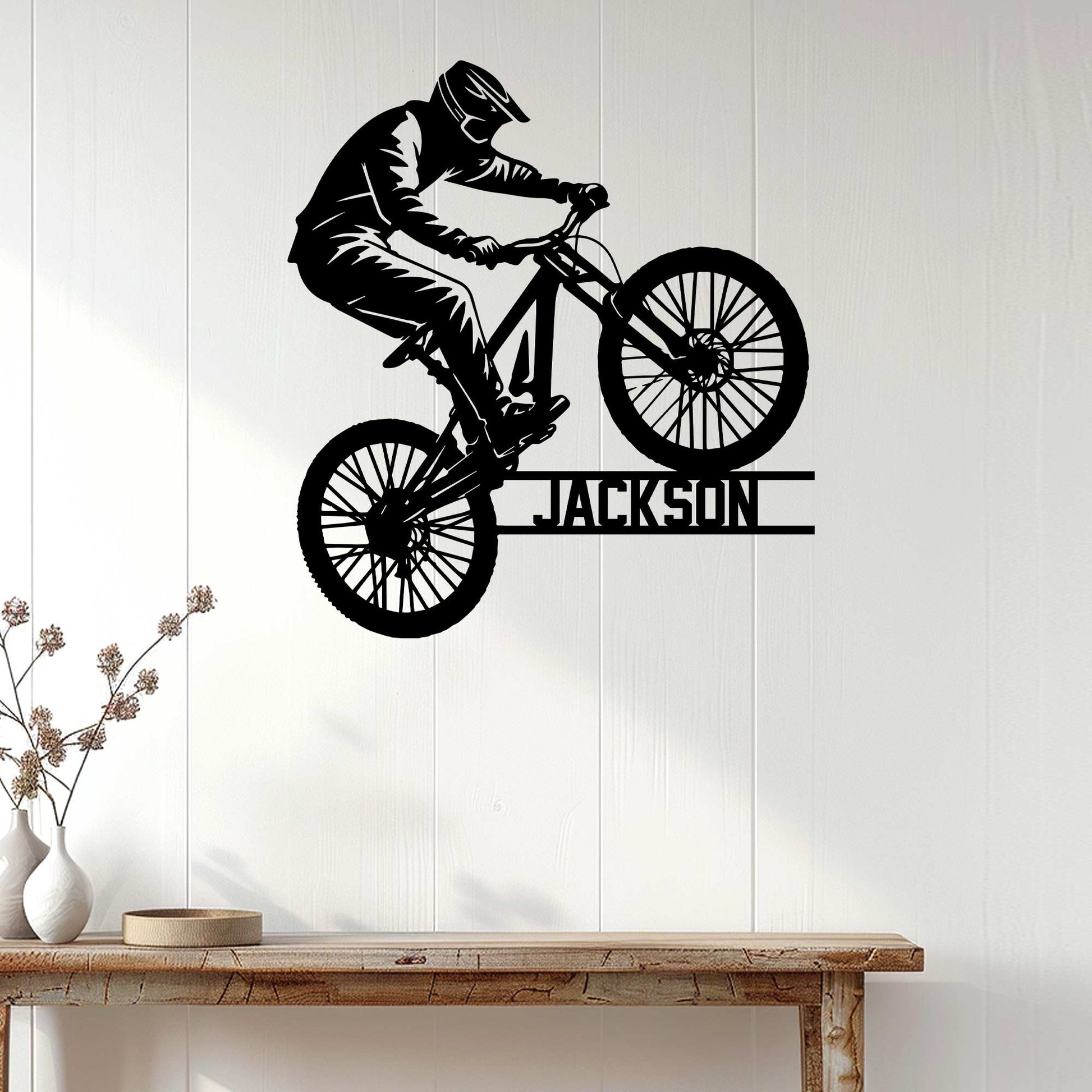 Mountain biking wall decor displayed above a console table in a bright modern home interior