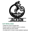 Mountain bike metal sign artwork shown with a circular tire design, mountain landscape, and forest silhouette