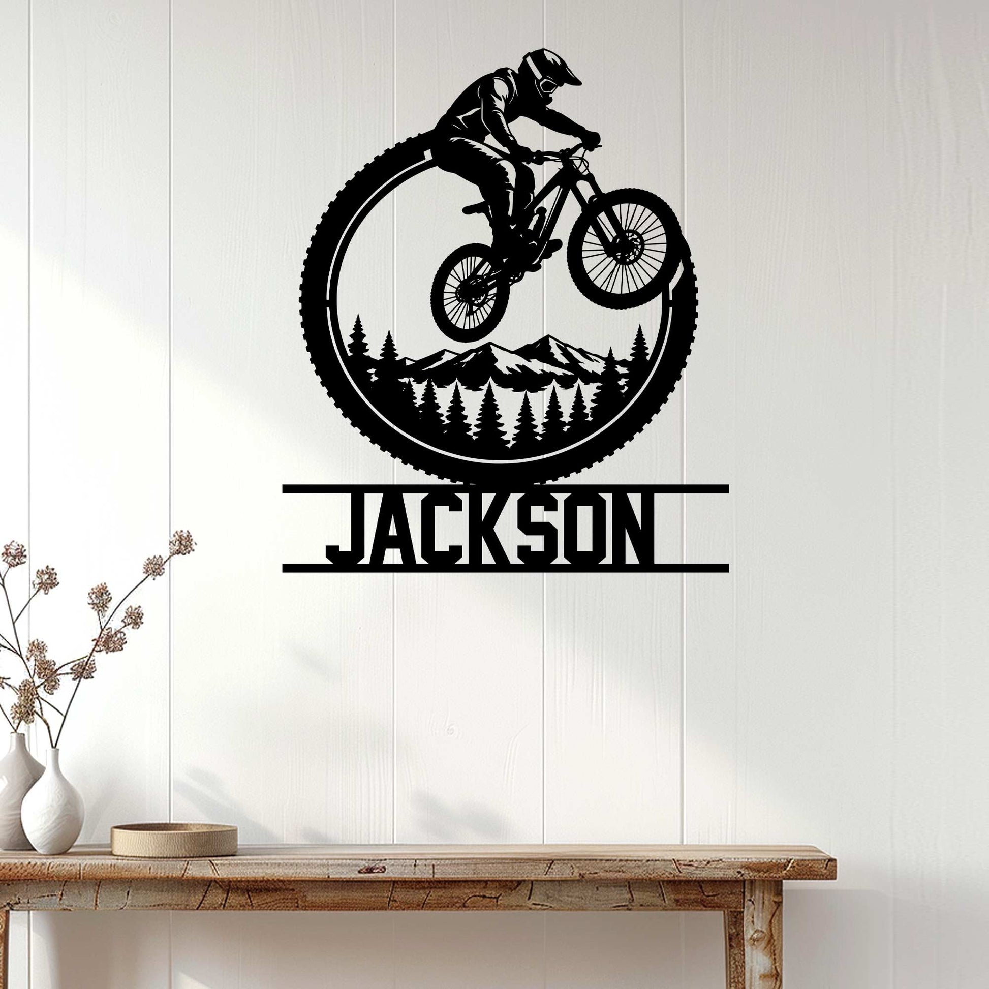 Mountain biking wall decor displayed on a light wood wall above a console table