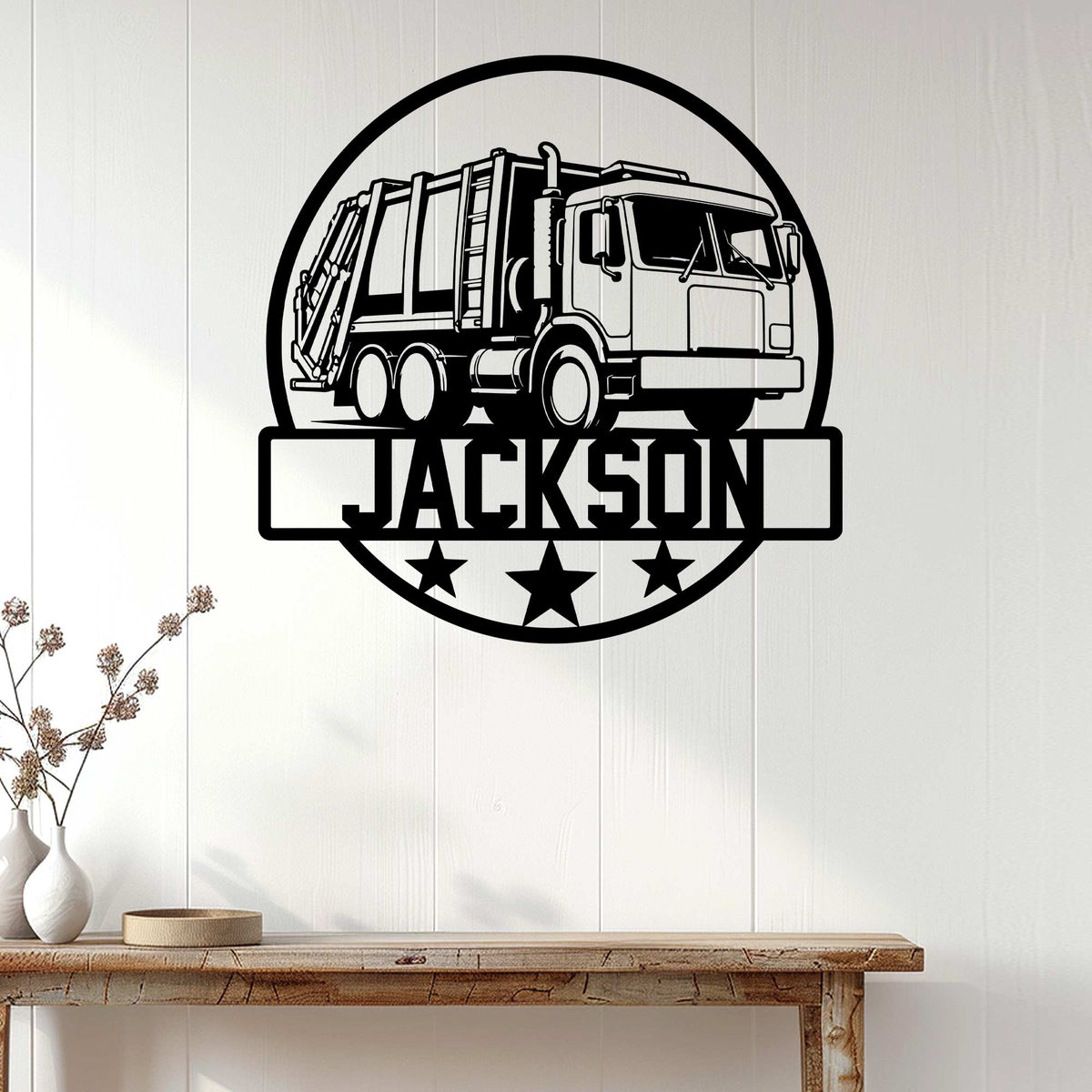 Garbage truck metal wall sign displayed on white paneling above a rustic console table in a bright room