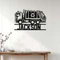 Garbage truck metal wall sign displayed on white wood paneling in a modern home entryway
