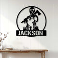 Black arborist wall sign displayed on white paneling above a wood console in a home interior