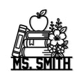 Teacher metal sign featuring stacked books, an apple, pencil, and floral design in bold black line art
