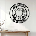 Black teacher metal wall sign displayed on a white paneled wall above a console table