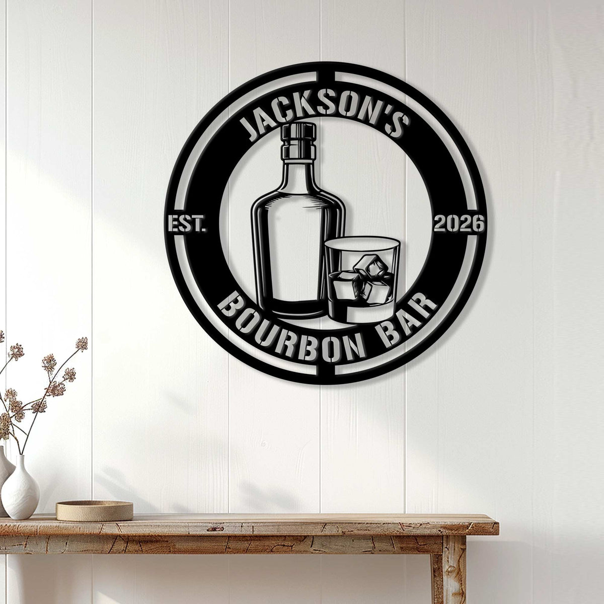 Bourbon bar metal sign displayed on a white paneled wall above a rustic console table