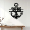 Nautical anchor metal sign displayed on a light paneled wall above a wooden console