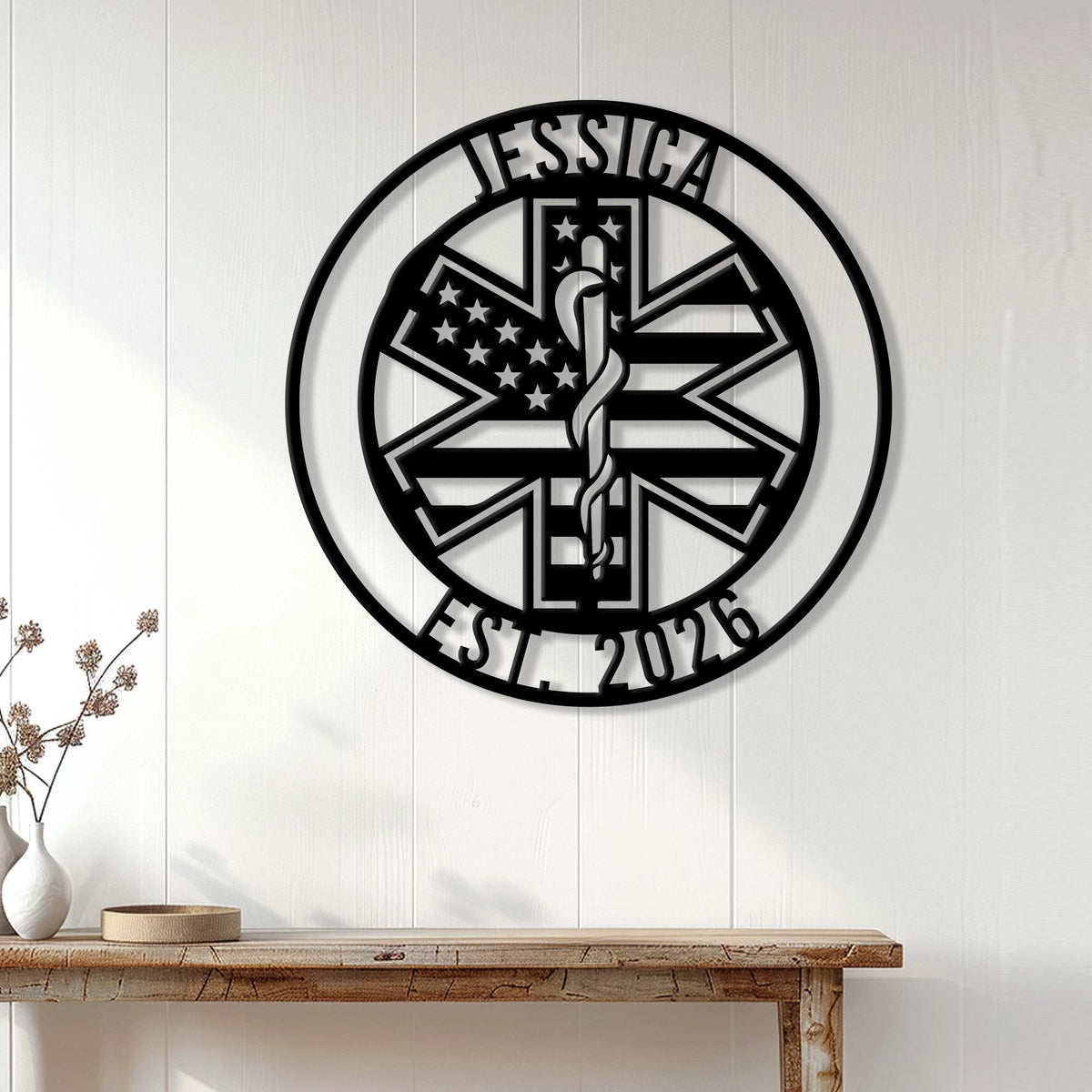 Black paramedic metal wall sign with a Star of Life displayed above a wood console in a home interior