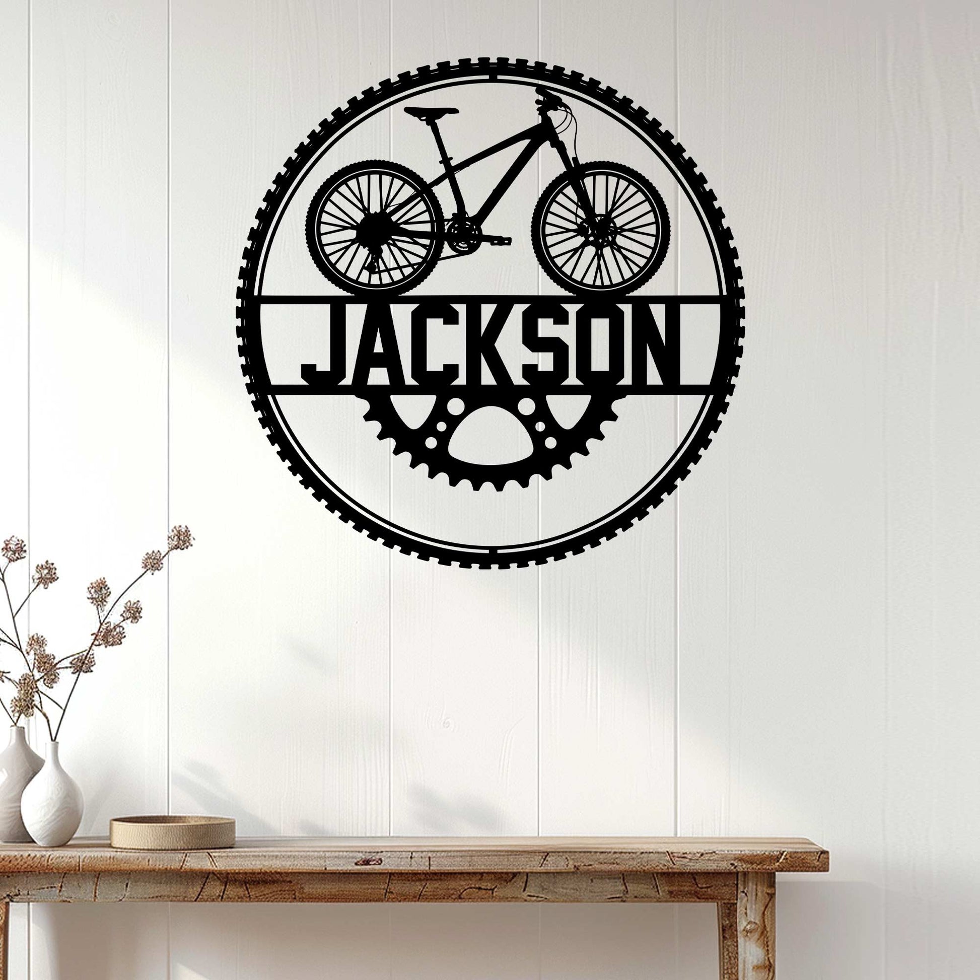 Cyclist wall sign displayed on white paneling above a console table in a bright home interior