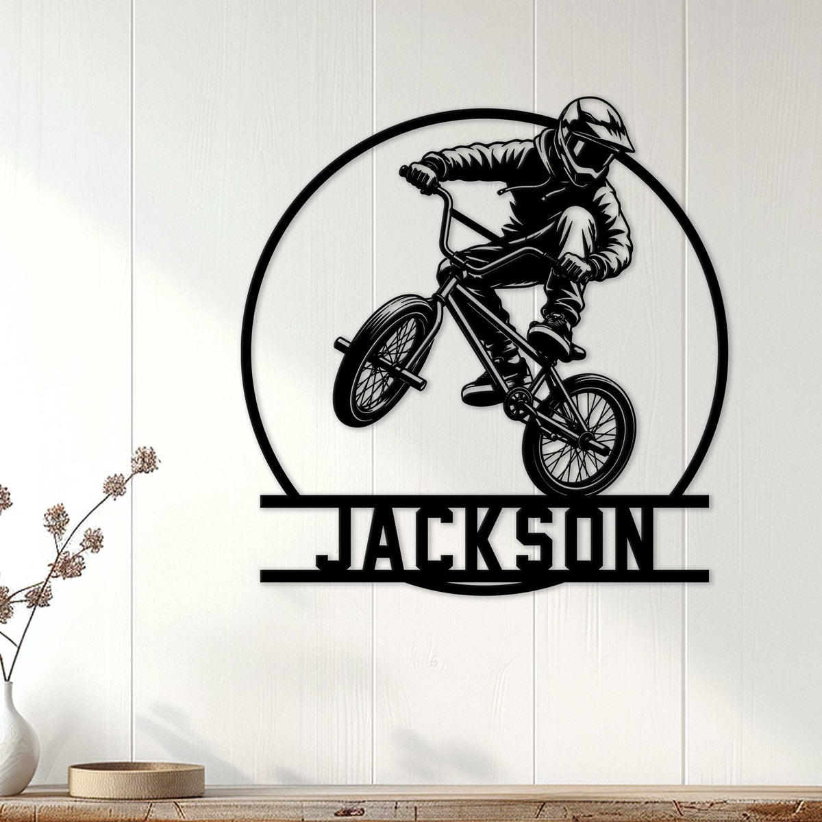 BMX wall sign displayed on white wood paneling above a console in a modern room