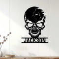 Black skull metal wall sign styled on a light paneled wall in a modern home setting