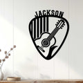 Guitar pick wall sign with acoustic guitar silhouette displayed on a bright paneled wall