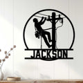 Lineman wall decor displayed on a light wood-paneled wall with a utility worker climbing a power pole