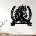 Black horse and horseshoe wall sign displayed on white wood paneling in a home decor setting