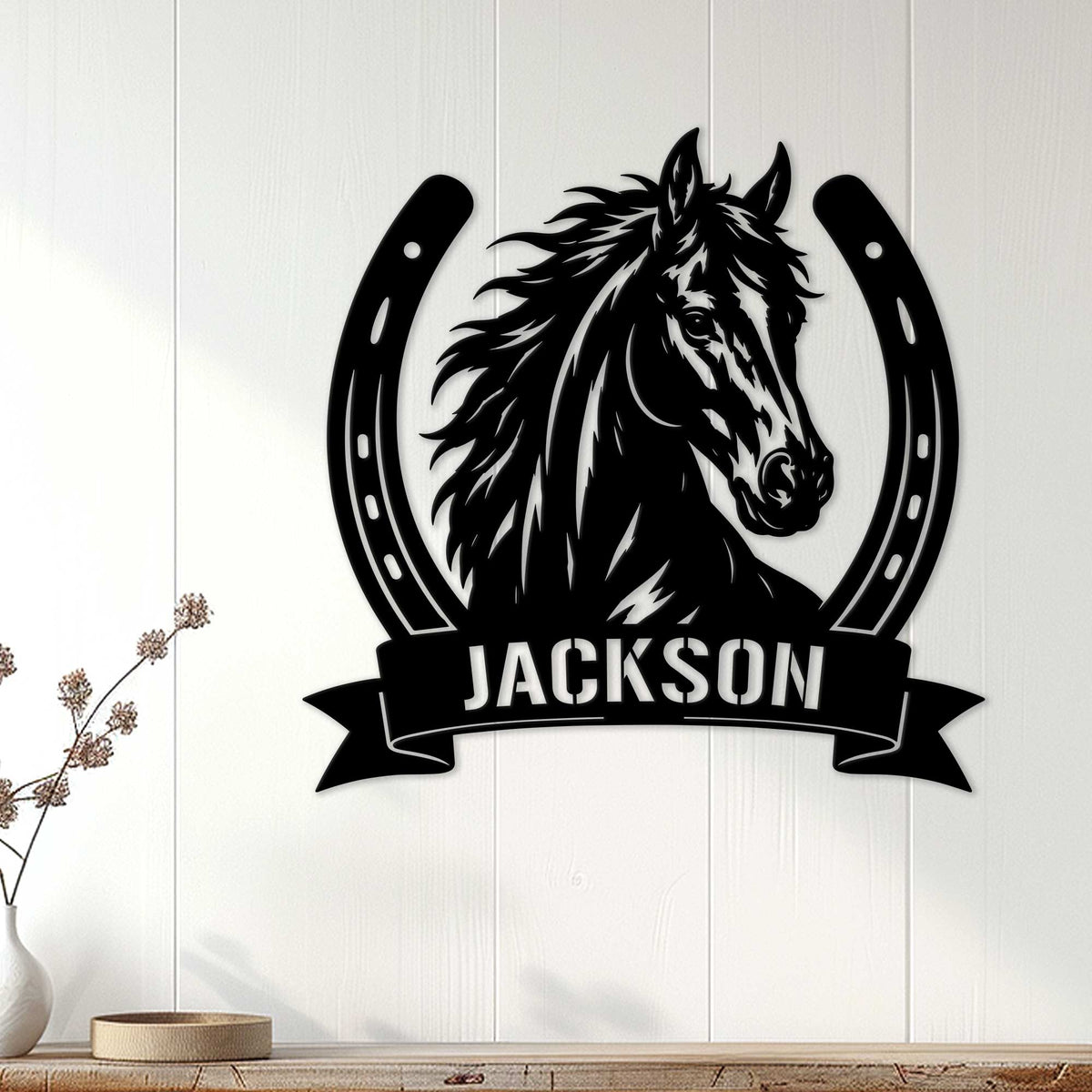 Black horse and horseshoe wall sign displayed on white wood paneling in a home decor setting