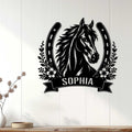 Black horse wall decor displayed on a white paneled wall above a wood console